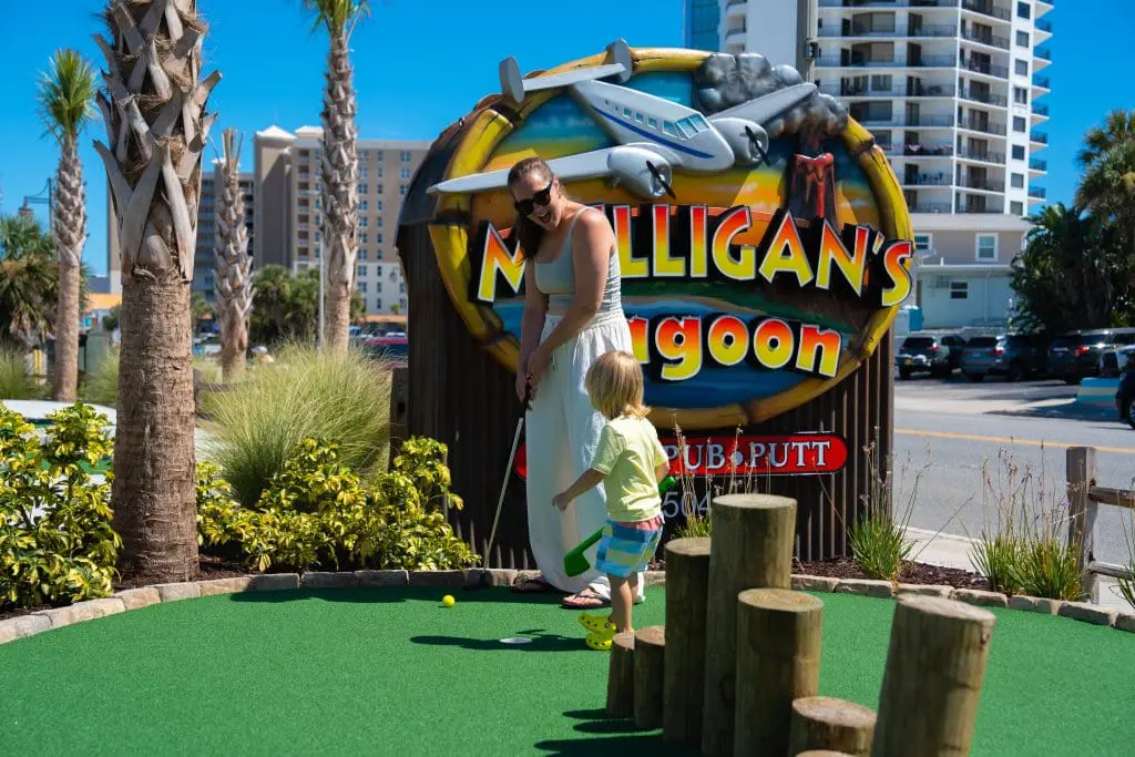 lady and kid playing mini golf