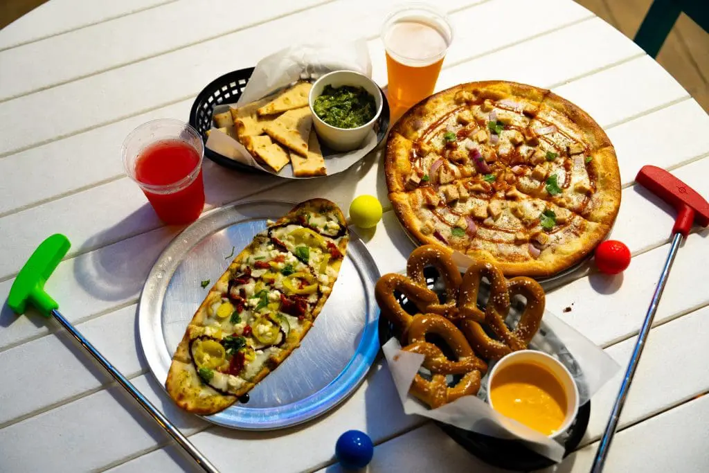 pizza, pretzels, drinks and mini golf clubs